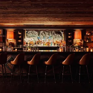 a bar with a long bar table and chairs