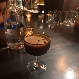 a drink in a glass on a bar