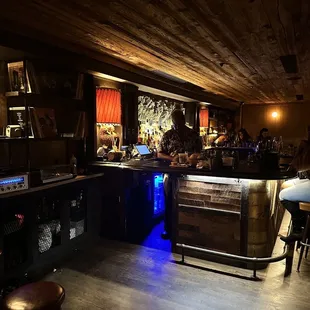 a bar with stools and tables