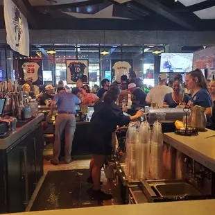 a crowd of people at a bar