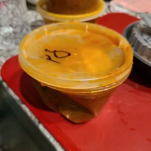 a bowl of soup with a face drawn on it