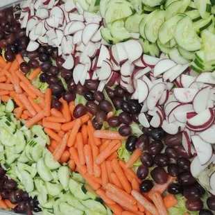 a variety of vegetables arranged on a platter