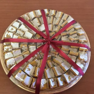 red ribbon wrapped around a silver platter