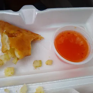 inside of appetizer with onion, potato, and sweet chili sauce