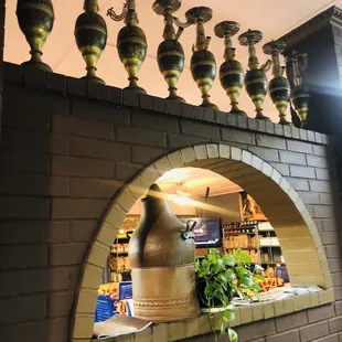 a brick wall with vases on top of it