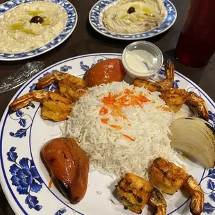 Shrimp plate with Baba Ganouj and Hummos background