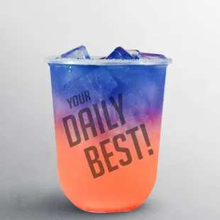 a blue and orange drink with ice
