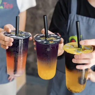 hree different drinks in plastic cups