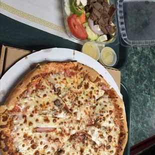 Pizza with Canadian bacon and sausage. Gyro salad with Tzatziki sauce.