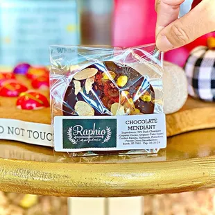 a hand grabbing a piece of chocolate