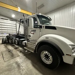 a large white truck in a garage