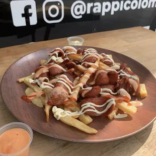 a plate of french fries and a cup of sauce