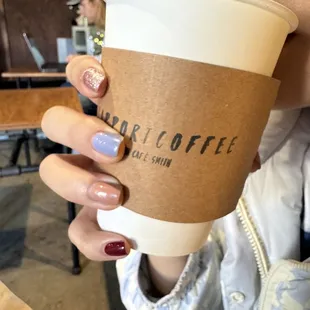 a woman holding a cup of coffee