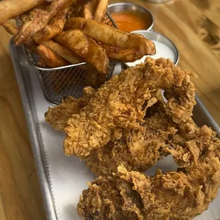 Chicken tenders, fries, and side sauces