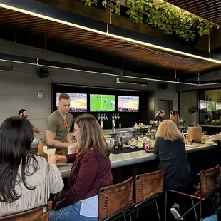 a group of people sitting at a bar