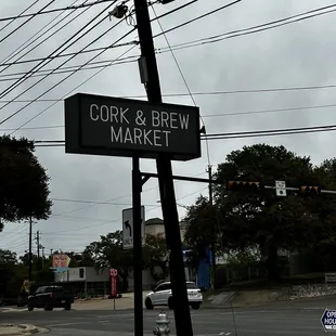 a street sign for cork and brew market