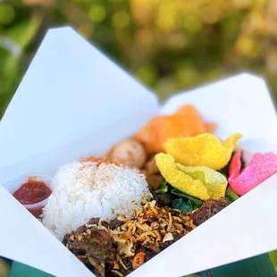 Beef Rendang Rice Platter w/ curry jackfruit, sautéed greens, egg, rice, crackers | $14