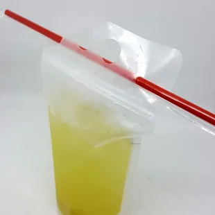 a drink in a plastic cup with a straw