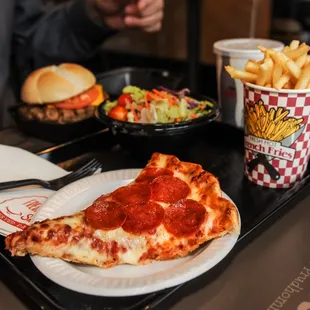 a slice of pepperoni pizza and french fries