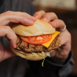 a man holding a hamburger