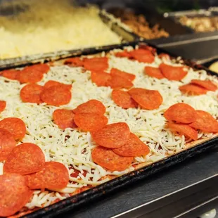 pepperoni and cheese on a pizza