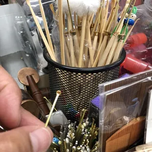 Ear pick tool / coining tool in the background