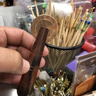 Coining tool and ear pick in background