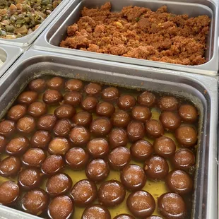 several trays of different types of food