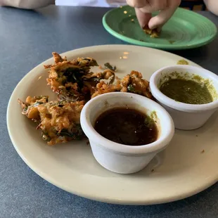 Yummy pakoras with tamarind chutney and cilantro chutney