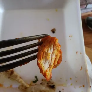 a piece of food on a plate with a fork