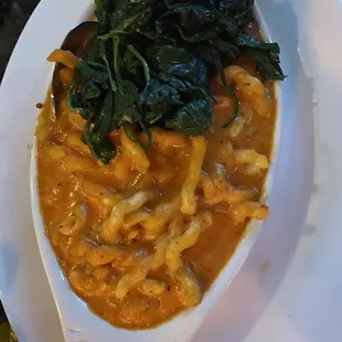Baked ziti (substituted with their homemade fusilli) topped with spinach.