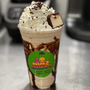 a chocolate milkshake with whipped cream and chocolate sprinkles