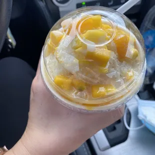 a person holding a drink in their hand