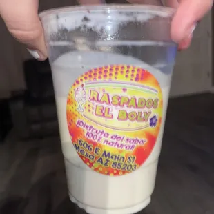 a person holding a plastic cup