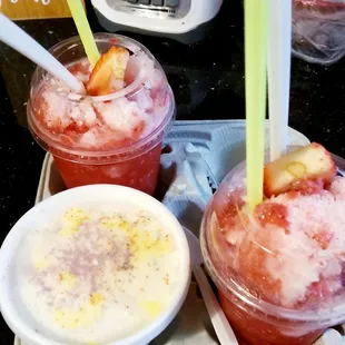 two cups of ice cream with strawberries and strawberries