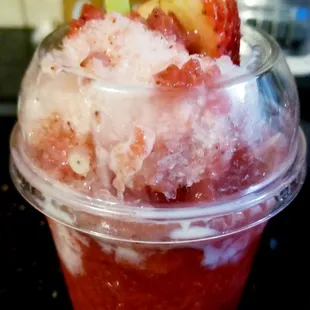 a cup of ice cream with strawberries