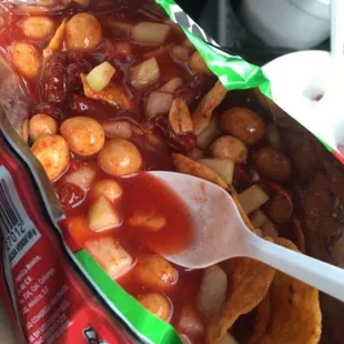 a person holding a bag of chips