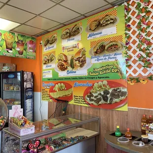 a man standing at a counter in a restaurant