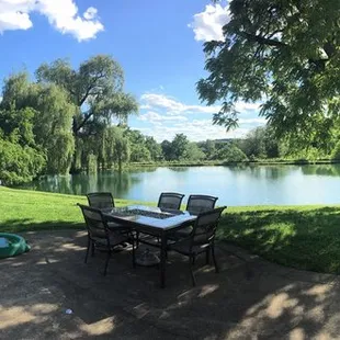 a view of a pond and picnic area