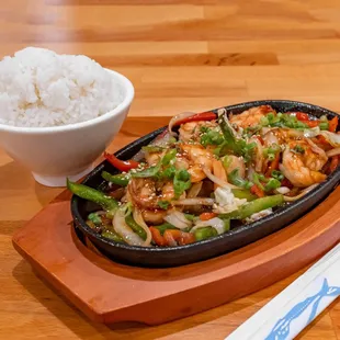 a bowl of rice and a plate of stir fry