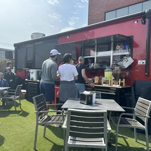 people standing around a food truck