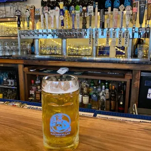 a pint of beer on a bar