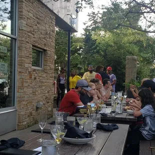 a group of people sitting at a picnic table