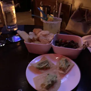 a plate of crackers and a bowl of olives