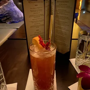 a cocktail with a garnish