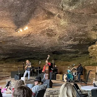 a band performing in a cave