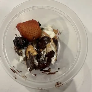 This Was a full cannoli but server chopped in half to fit into to go cup. Ugh.