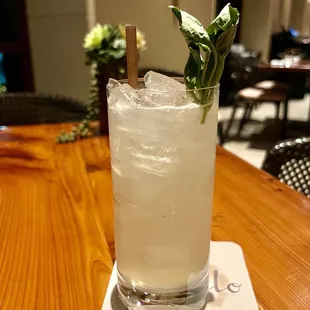 a glass of a drink on a wooden table