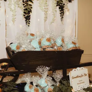 a wheelbarrow decorated with cookies and flowers
