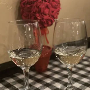 two glasses of wine on a table